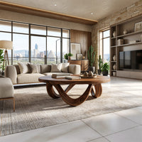 Figure eight base coffee table in a sunlit room with large windows and plants