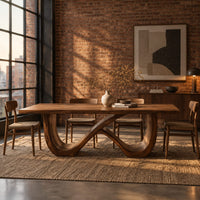 Rectangular dining table on an infinity loop base of curved wood in an industrial loft dining room with exposed brick