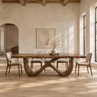 Rectangular dining table on an infinity loop base of curved wood in a bright open plan dining room