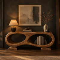Console table shaped like a figure eight with two oval openings in a dark entryway at golden hour