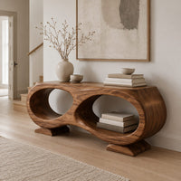Console table shaped like a figure eight with two oval openings in a Scandinavian entryway with white walls