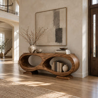 Console table shaped like a figure eight with two oval openings in a bright open plan entryway