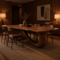 Dining table with a flowing figure eight loop base in an evening dining room with walnut wall paneling