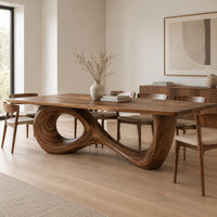 Dining table with a flowing figure eight loop base in a Scandinavian dining room with white walls