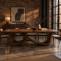 Dining table with a flowing figure eight loop base in an industrial loft dining room with exposed brick