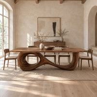 Dining table with a flowing figure eight loop base in a bright open plan dining room