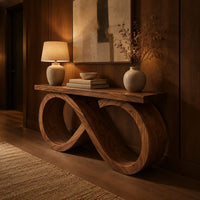 Console table with an infinity loop base and a plank top in an evening entryway with walnut wall paneling