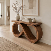 Console table with an infinity loop base and a plank top in a Scandinavian entryway with white walls