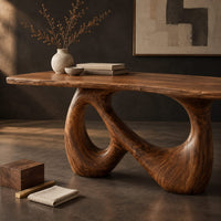 Corner detail of dining table on a single figure eight loop base with two open holes beside wood, brass and linen samples