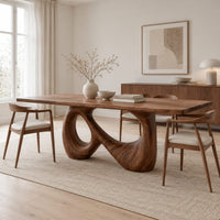 Dining table on a single figure eight loop base with two open holes in a Scandinavian dining room with white walls