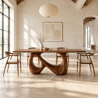 Dining table on a single figure eight loop base with two open holes in a bright open plan dining room