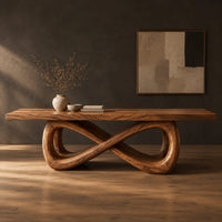 Rectangular dining table on a figure eight loop base with a thick plank top in a dark studio against a charcoal plaster wall