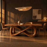 Rectangular dining table on a figure eight loop base with a thick plank top in a dark dining room at golden hour