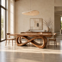 Rectangular dining table on a figure eight loop base with a thick plank top in a bright open plan dining room