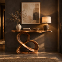 Console table with a figure eight wooden pedestal and a narrow natural edge top in a dark entryway at golden hour