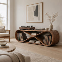 Low record console shaped like a figure eight with open bays at each end in a Scandinavian living room with white walls
