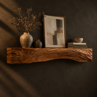 Fireplace mantel with carved flowing grain ridges and a wavy lower edge, three-quarter view showing the grain