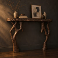 Fireplace mantel with a carved top slab and twisted branch shaped legs, three-quarter view showing the grain