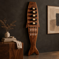 Corner detail of tall fish shaped wine rack with angled bottle slots and stemware slots beside wood, brass and linen samples