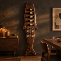 Tall fish shaped wine rack with angled bottle slots and stemware slots in a dark dining room at golden hour