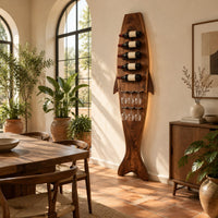 Tall fish shaped wine rack with angled bottle slots and stemware slots in a bright dining room with arched windows and plants