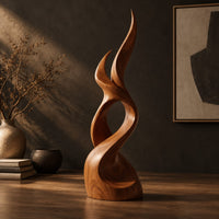 Flame shaped wood sculpture with two pointed tips and a swirling base, three-quarter view showing the grain