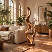 Flame shaped floor lamp with a glowing edge and a small shelf in a bright living room with arched windows and plants