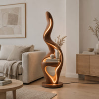Flame shaped floor lamp with a glowing edge and a small shelf in a Scandinavian living room with white walls