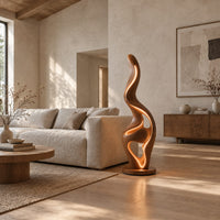 Flame shaped floor lamp with a glowing edge and a small shelf in a bright open plan living room