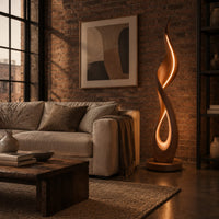 Flame shaped floor lamp with a glowing teardrop opening on a disc base in an industrial loft living room with exposed brick