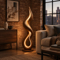 Flame shaped wooden floor lamp with a glowing loop on a disc base in an industrial loft living room with exposed brick