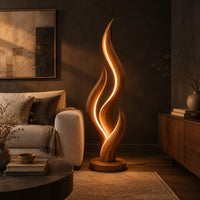 Flame shaped floor lamp with layered tongues and a glowing seam in a dark living room at golden hour