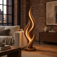 Flame shaped floor lamp with layered tongues and a glowing seam in an industrial loft living room with exposed brick
