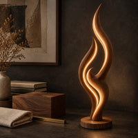 Corner detail of tall flame shaped floor lamp with layered wooden ribbons on a disc base beside wood, brass and linen samples