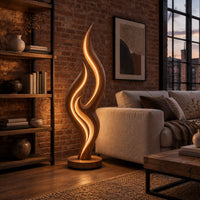 Tall flame shaped floor lamp with layered wooden ribbons on a disc base in an industrial loft living room with exposed brick