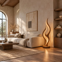 Tall flame shaped floor lamp with layered wooden ribbons on a disc base in a bright open plan living room