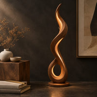 Corner detail of flame shaped floor lamp with an open loop base and inner glow beside wood, brass and linen samples