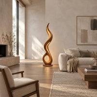 Flame shaped floor lamp with an open loop base and inner glow in a bright open plan living room