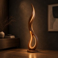 Flame shaped floor lamp with an open teardrop loop and a glowing edge, three-quarter view showing the grain