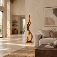 Flame shaped floor lamp with an open teardrop loop and a glowing edge in a bright open plan living room