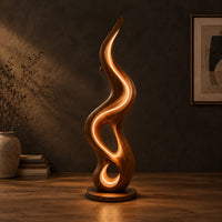 Flame shaped wooden lamp with open loops and a glowing edge line in a dark studio against a charcoal plaster wall