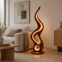 Flame shaped wooden lamp with open loops and a glowing edge line in a Scandinavian living room with white walls