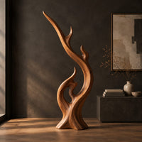 Flame shaped wood sculpture with a long sweeping arm and an open loop, three-quarter view showing the grain