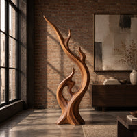 Flame shaped wood sculpture with a long sweeping arm and an open loop in an industrial loft living room with exposed brick
