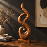 Flowing flame sculpture with a spiral scroll at its foot and a block base, three-quarter view showing the grain