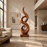 Flowing flame sculpture with a spiral scroll at its foot and a block base in a bright open plan living room