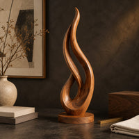 Corner detail of flame shaped wood sculpture with an open loop on a disc base beside wood, brass and linen samples