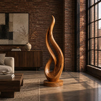 Flame shaped wood sculpture with an open loop on a disc base in an industrial loft living room with exposed brick