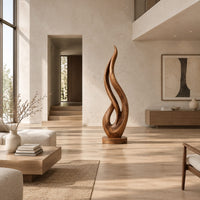 Flame shaped wood sculpture with an open loop on a disc base in a bright open plan living room