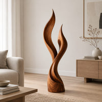 Wood sculpture shaped like two rising flames with smooth swept lines in a Scandinavian living room with white walls